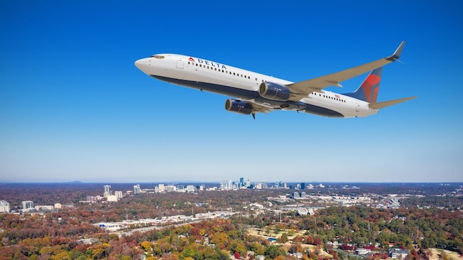 A Boeing 737 operated by Delta Air Lines, which is headquartered in Atlanta, flies over the city. CREDIT: Delta Air Lines