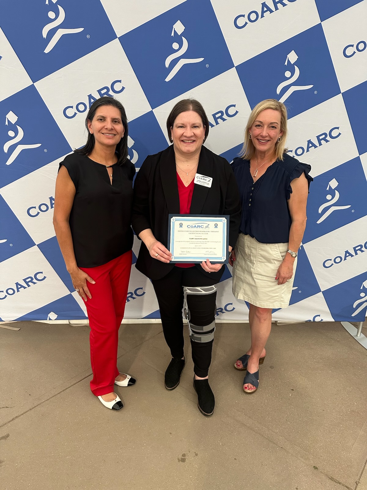 Nancy Guyse and Teri Miller holding the Distinguished Credentialing Success award at the CoARC Awards Ceremony and Reception in Snowbird, Utah.