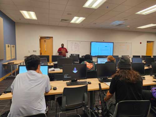 IT students listen to a class presentation.