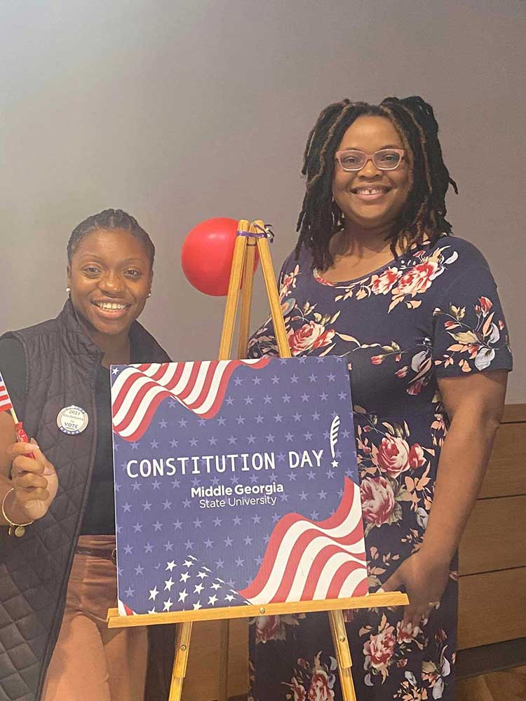 MGA staff wave flags as they celebrate Constitution Day 2024.