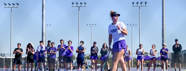 Knights tennis players cheering each other on during a match.