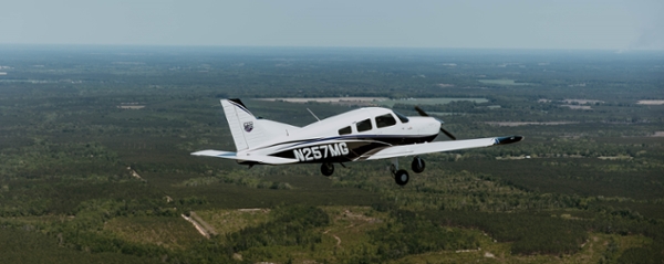 MGA plane flying over Eastman.