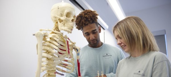 Rehab Science Club students examine a skeleton.