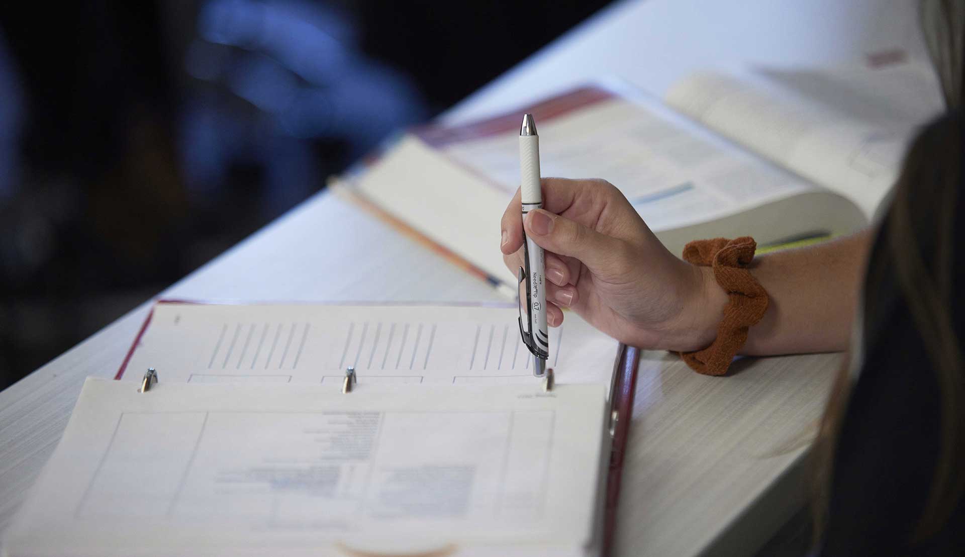 Close up phot of an open textbook and pen. 