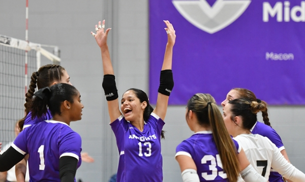 MGA Knights volleyball players celebrating on the court. 