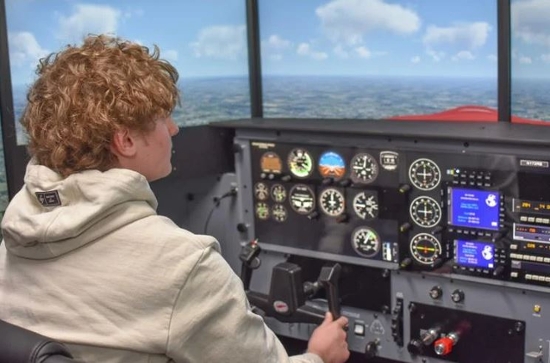 Trinity student tries out the flight simulator.