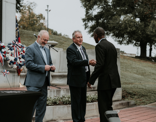 Chris Blake and Lester Miller greet attendees at the Veterans Day Ceremony at Coleman Hill in Macon.