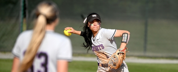 MGA softball player throws the ball during a game.