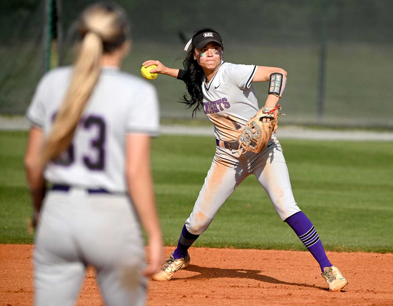 MGA softball player throws the ball during a game.