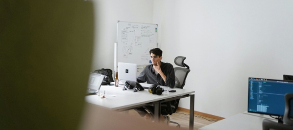 Man works at an office desk. 