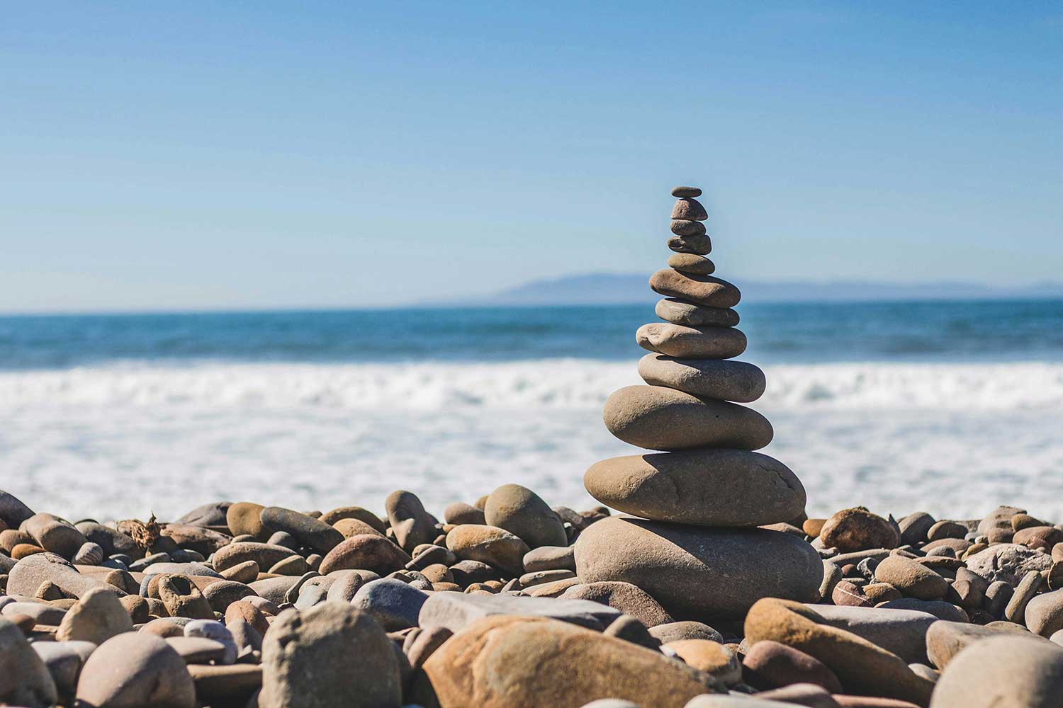 Stack of mediation stones on a beach.
