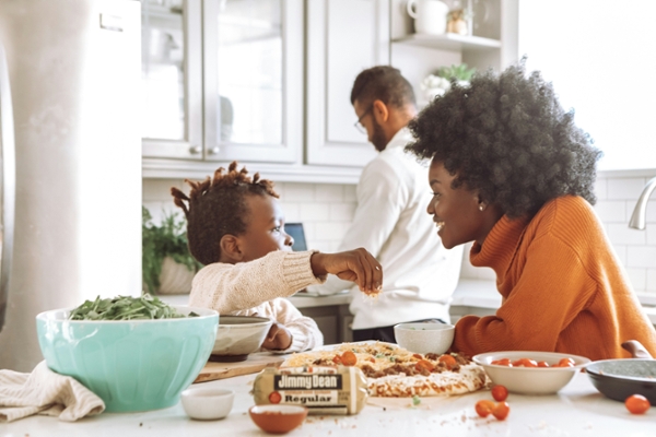 Black family cooking breakfast together. 