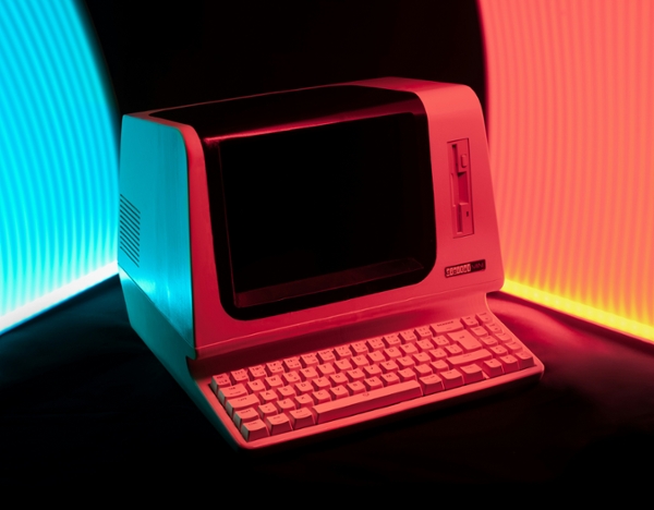 Vintage computer lit with neon lights. 