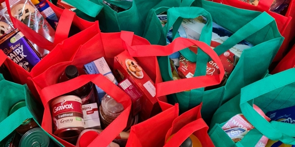 Reusable grocery bags filled with food items. 