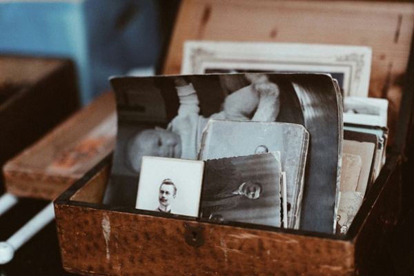 Wooden box filled with various old, historical photos.