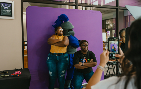 Students pose for photos with Duke the Knight at a Student Life event.