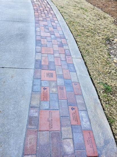 Commemorative bricks on the walkway of the Peyton Anderson Enrollment Center on MGA's Macon Campus.