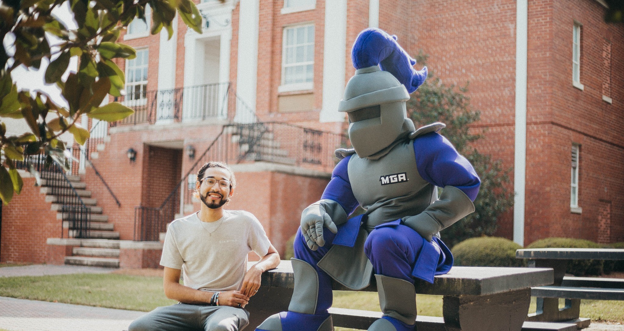 Duke sits with a student outside at MGA's Cochran Campus.