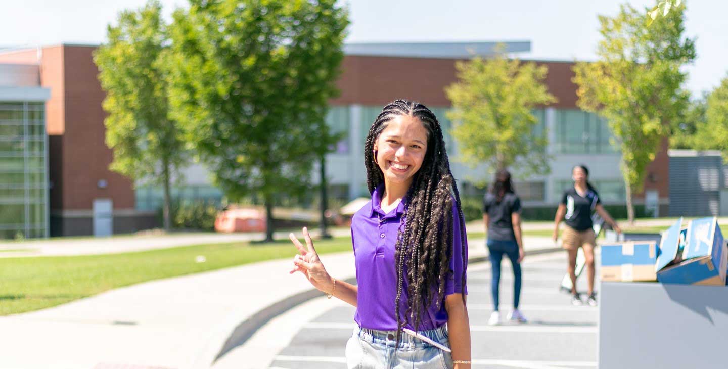 Female volunteer poses for a photo on Fall Move-In Day 2024.