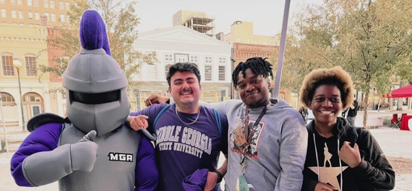 Duke poses with MGA students in downtown Macon.