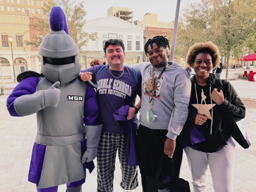 Duke poses with MGA students in downtown Macon.