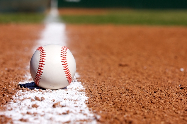 Baseball sits on a field.