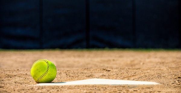 Softball sits on a base. 
