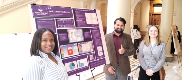 Taylor Reaves and Amya Smith, MGA information technology students from Dr. Karim Feroz's ITEC 3155 class, participated in Posters at the Georgia State Capitol, showcasing their innovative work alongside Dr. Kevin Floyd, associate dean for the School of Computing. 