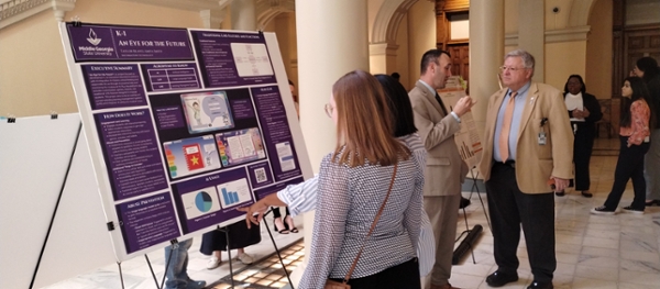 Taylor Reaves and Amya Smith, MGA information technology students from Dr. Karim Feroz's ITEC 3155 class, participated in Posters at the Georgia State Capitol, showcasing their innovative work alongside Dr. Kevin Floyd, associate dean for the School of Computing. 