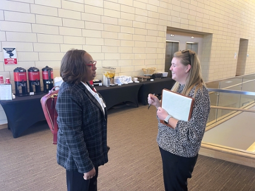 Teacher Education Mock Interview Day and School District Showcase participants exchange a laugh at the event.