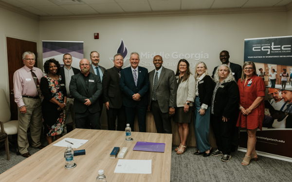 Leaders from MGA and CGTC sign an agreement at an October 2 event at Middle Georgia State’s Macon Campus. 