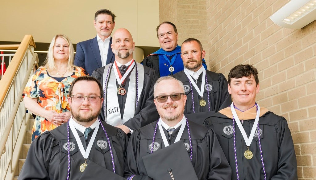 Robins AFB representatives and Dean Marc Miller with the first MGA-Robins strategic partnership cohort at spring commencement.