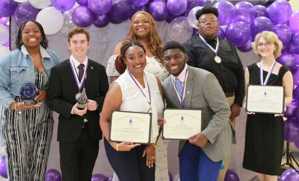 Students pose for photos holding their leadership awards at Student Life's Leadership Awards Ceremony. 