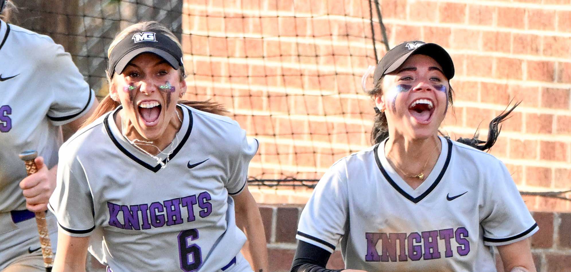 MGA Knights softball players yelling in excitement. 