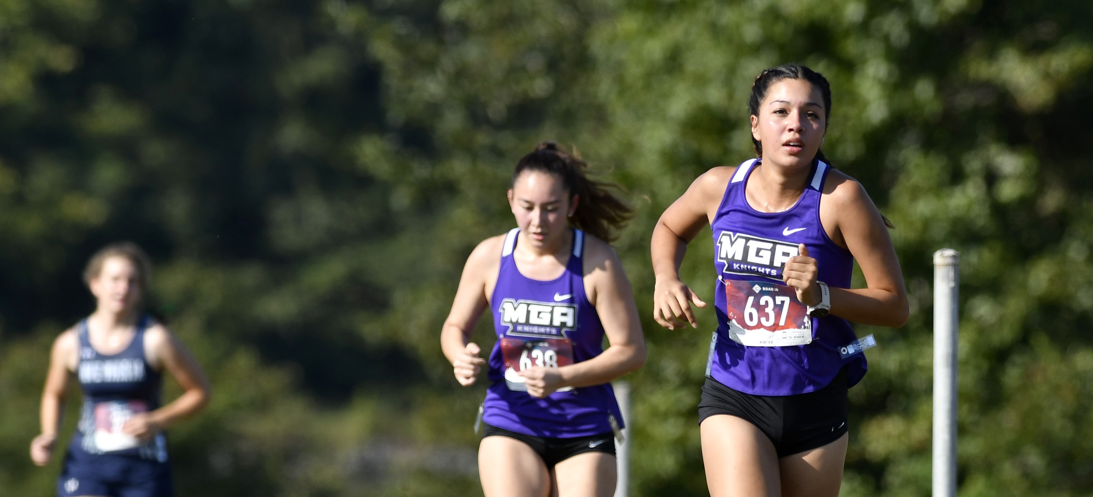 MGA's women's cross country team running during a meet.