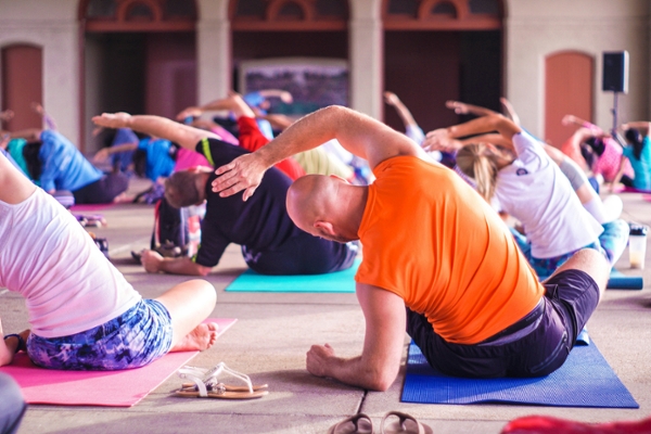 People stretch in a yoga class.