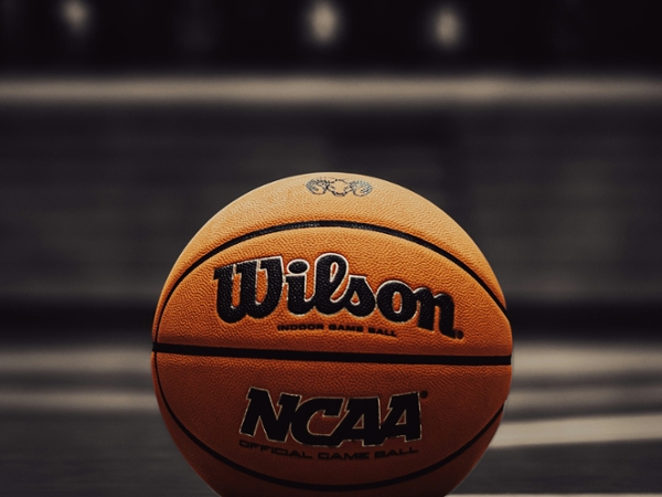 Cloe up of  basketball sitting on a court.