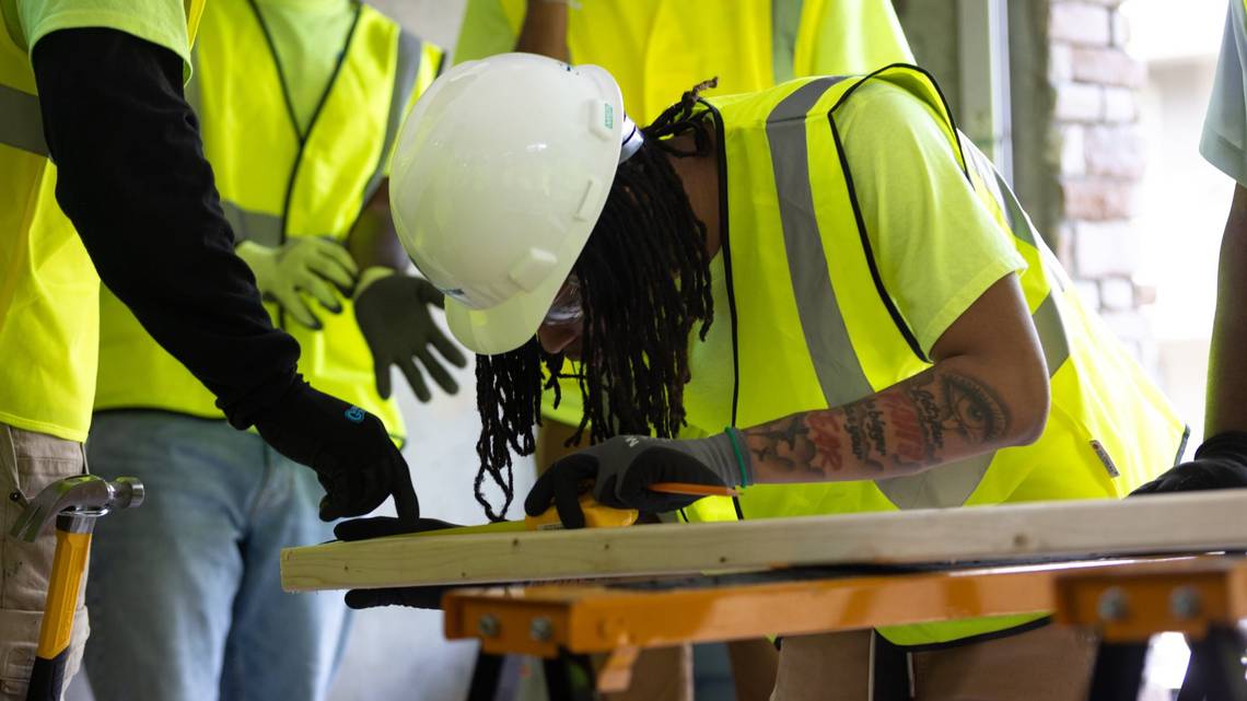 sac Edwards, a student in the Construction Ready program, measures a piece of wood during a hands-on exercise at Westside Works in Atlanta. (Arvin Temkar/AJC) Arvin Temkar TNS  Read more at: https://www.macon.com/news/article309046585.html#storylink=cpy
