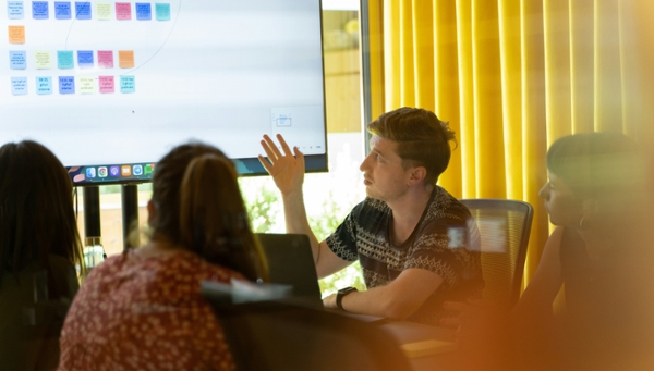 Man gives a PowerPoint presentation.