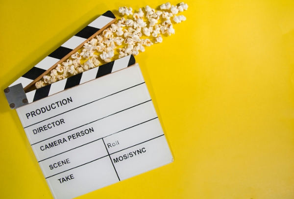 Flat lay of popcorn emerging from a clapper board. 