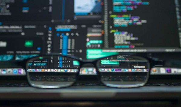 Glasses sitting on a laptop.