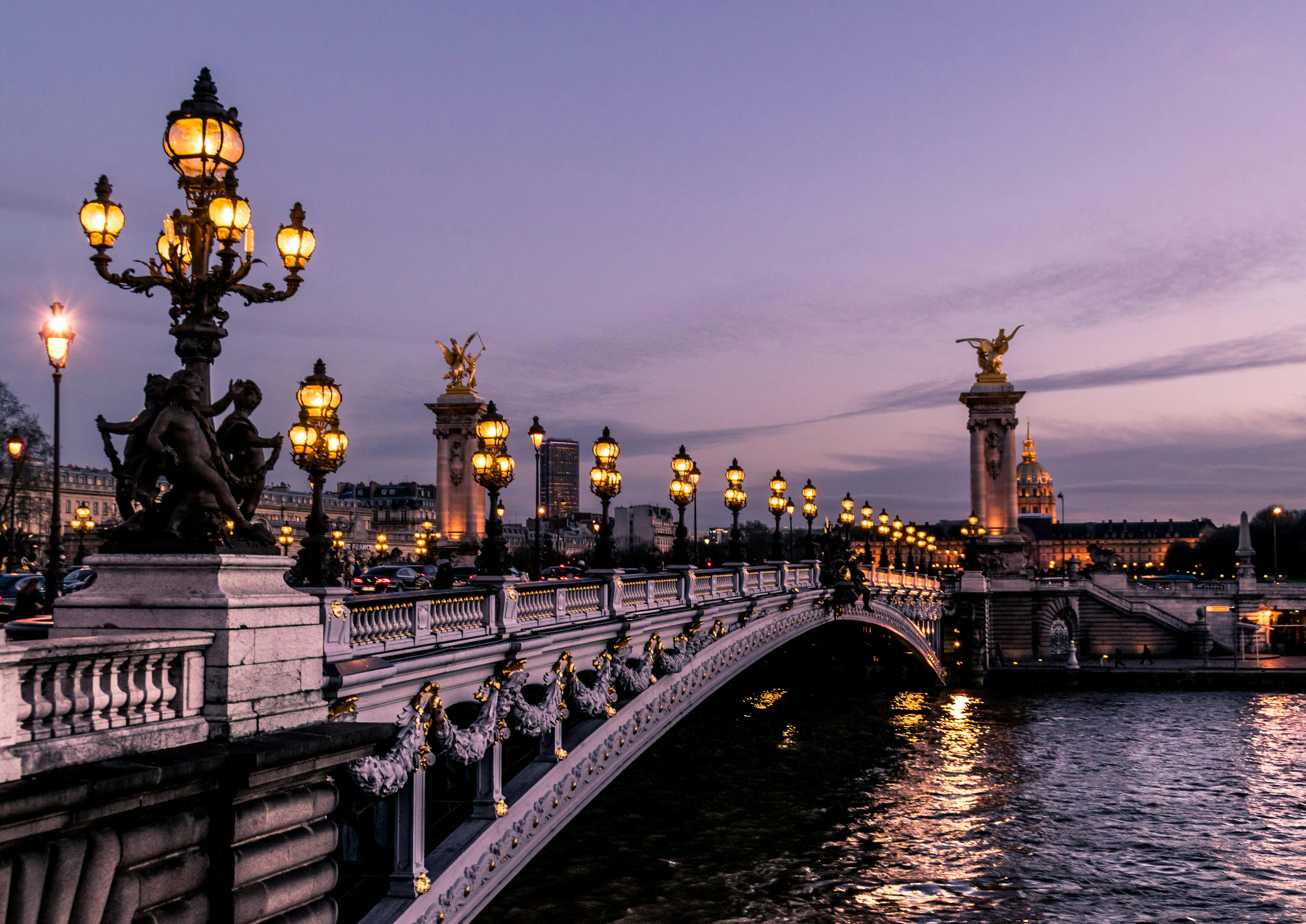 Lighted bridge at dusk in Paris, France.