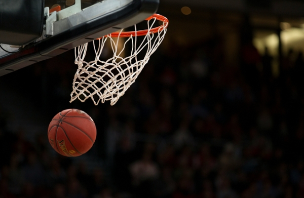 Basketball swishes in a basket.