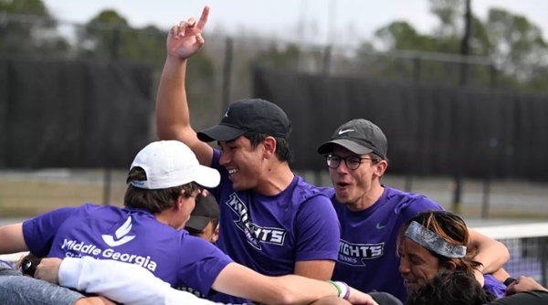 Knights men's tennis celebrates a win on the court.