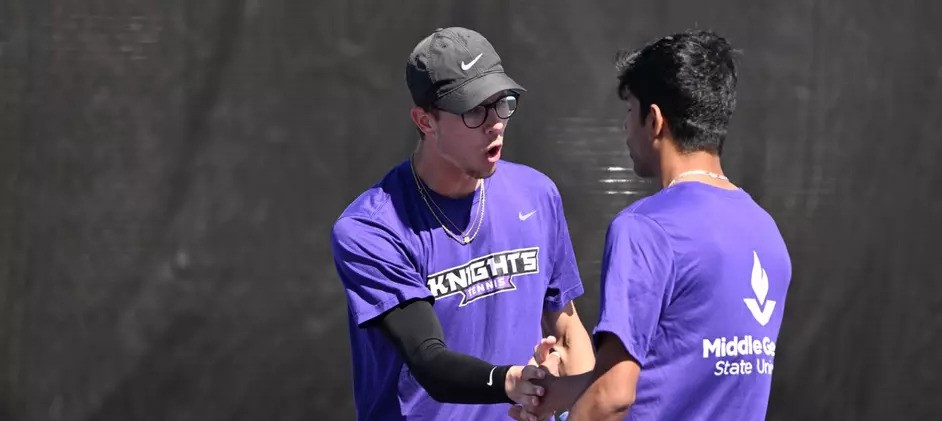 Knights men's tennis players shake hands during a match.