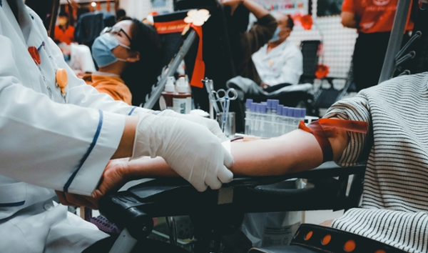 Person donates blood at a blood drive.