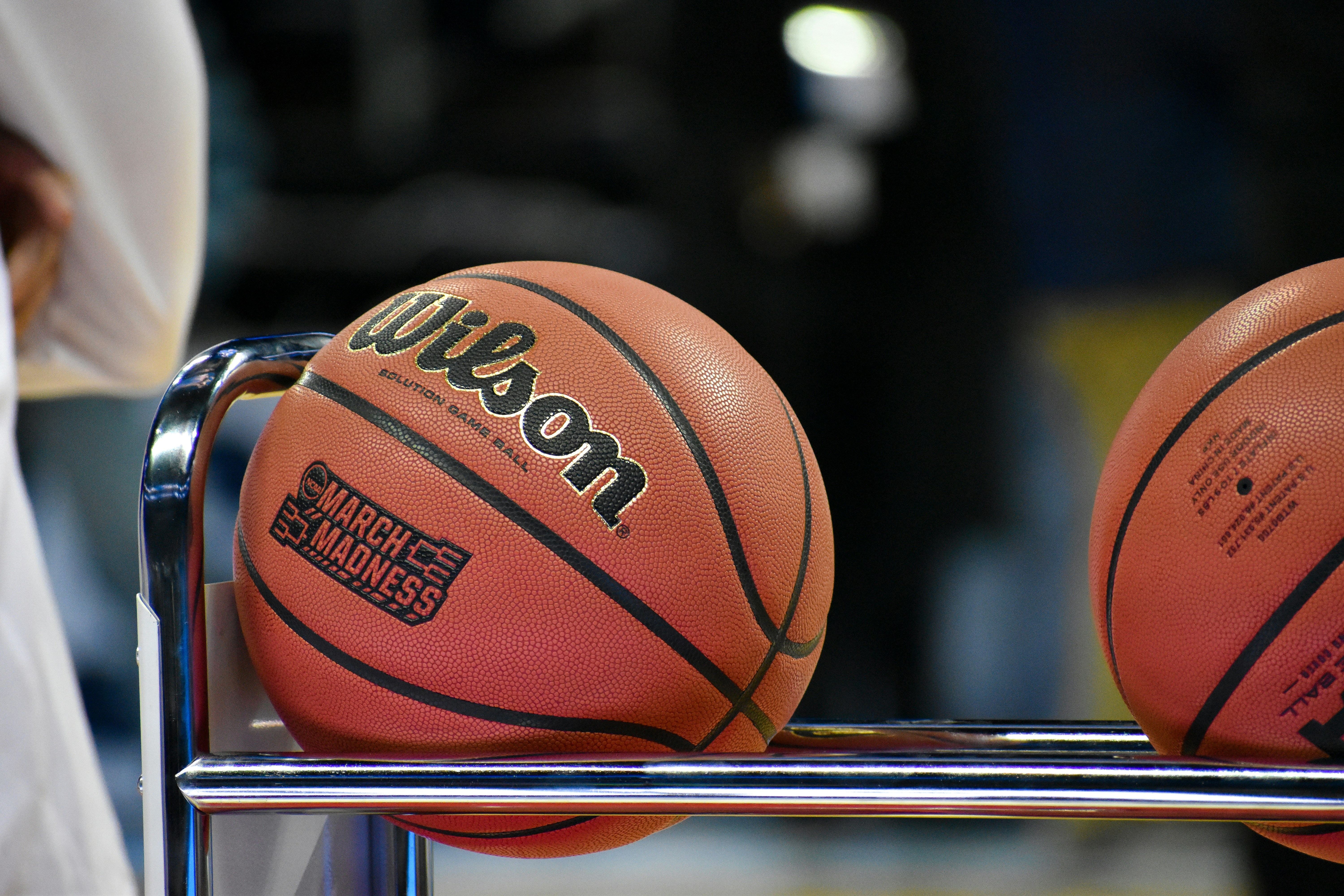 Wilson basketballs on rack.