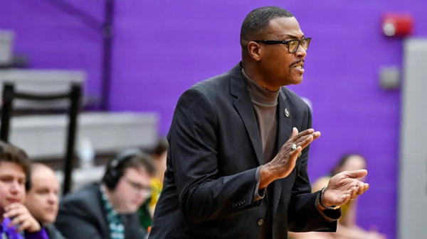 Anderson Ligon cheers on the women's basketball team courtside.