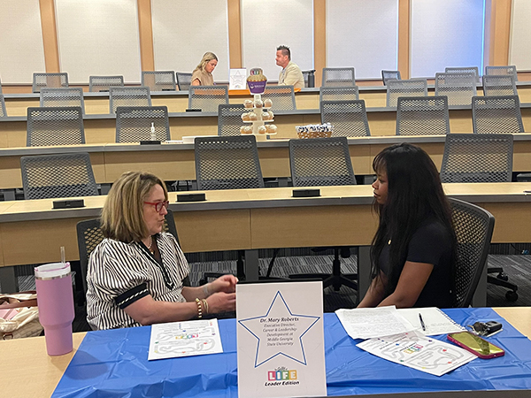 Health Sciences Leadership student interviewing Dr. Mary Roberts.