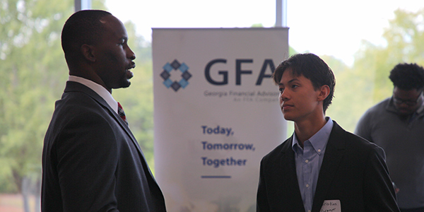 MGA student speaking with a job recruiter at a career fair.
